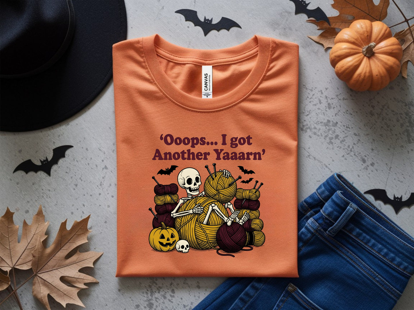 Orange t-shirt with skeleton knitting yarn, text says "Ooops... I got Another Yaaarn".