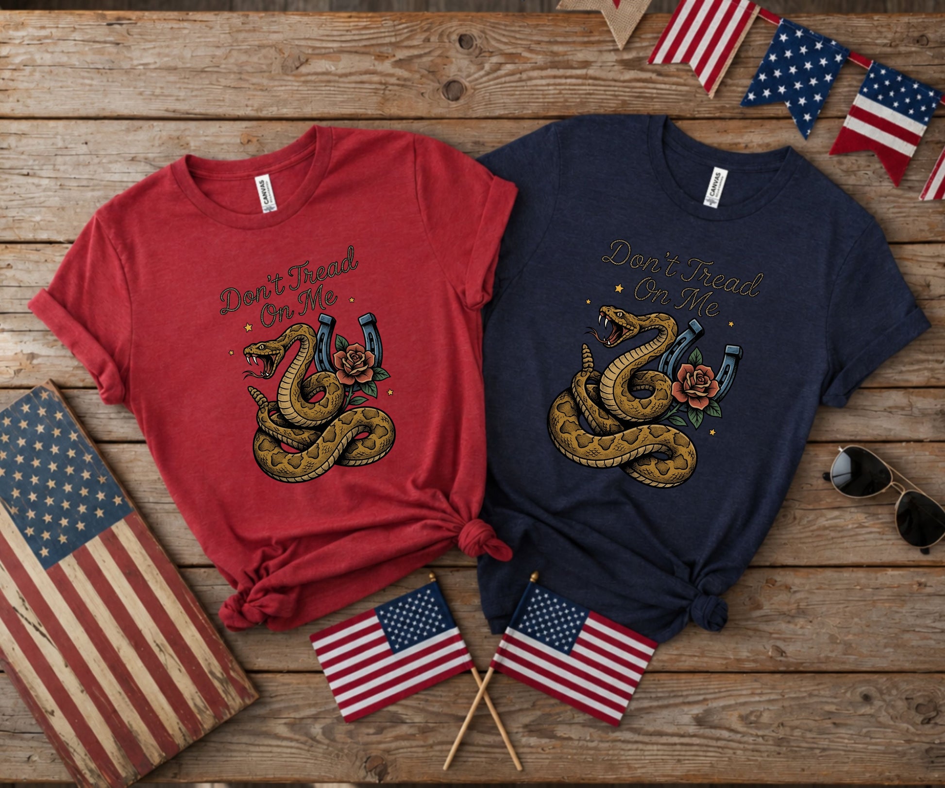 Two t-shirts, red and navy, featuring a coiled rattlesnake and horseshoe.