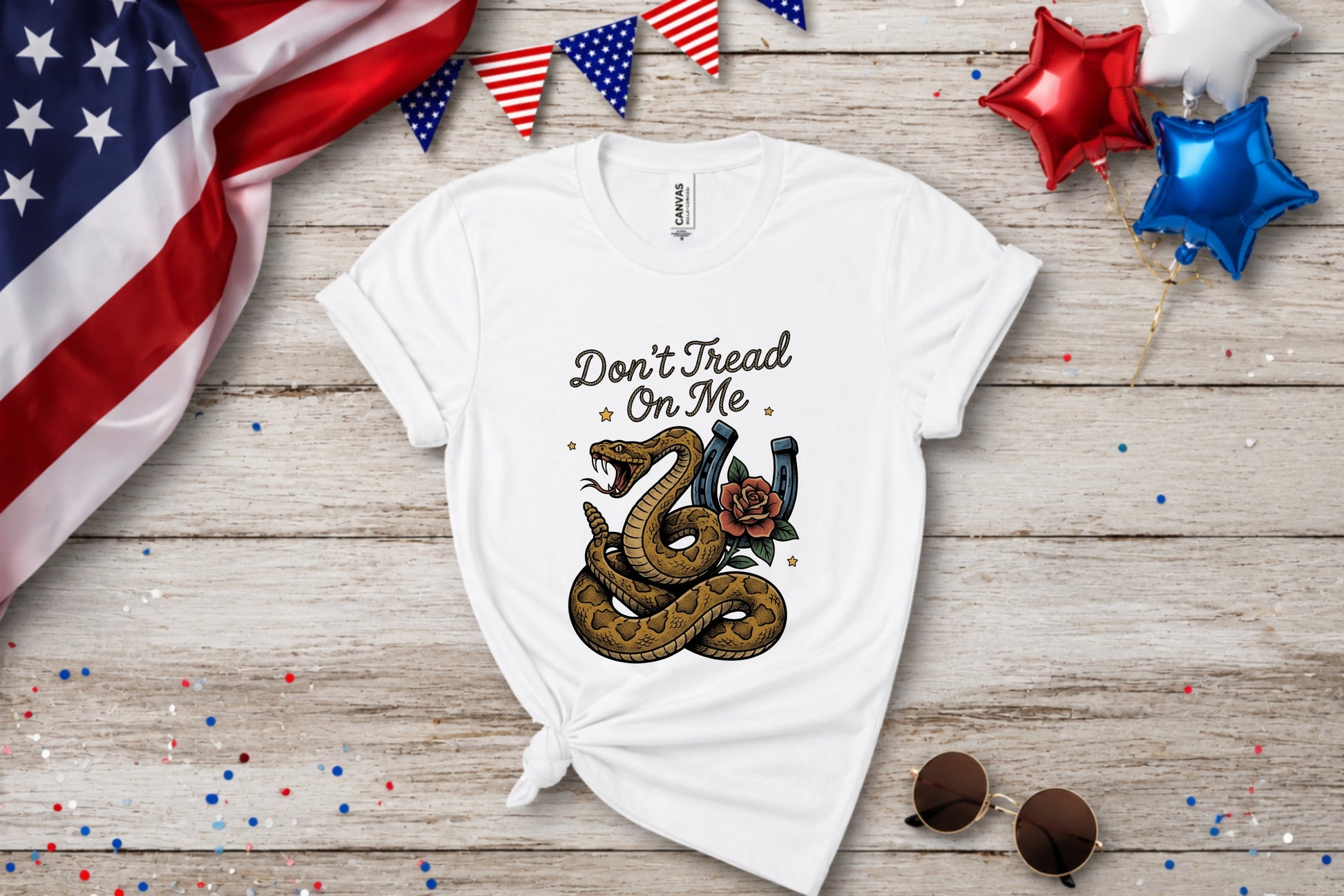 White t-shirt with a coiled snake and horseshoe graphic that reads "Don't Tread On Me."