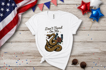 White t-shirt with a coiled snake and horseshoe graphic that reads "Don't Tread On Me."