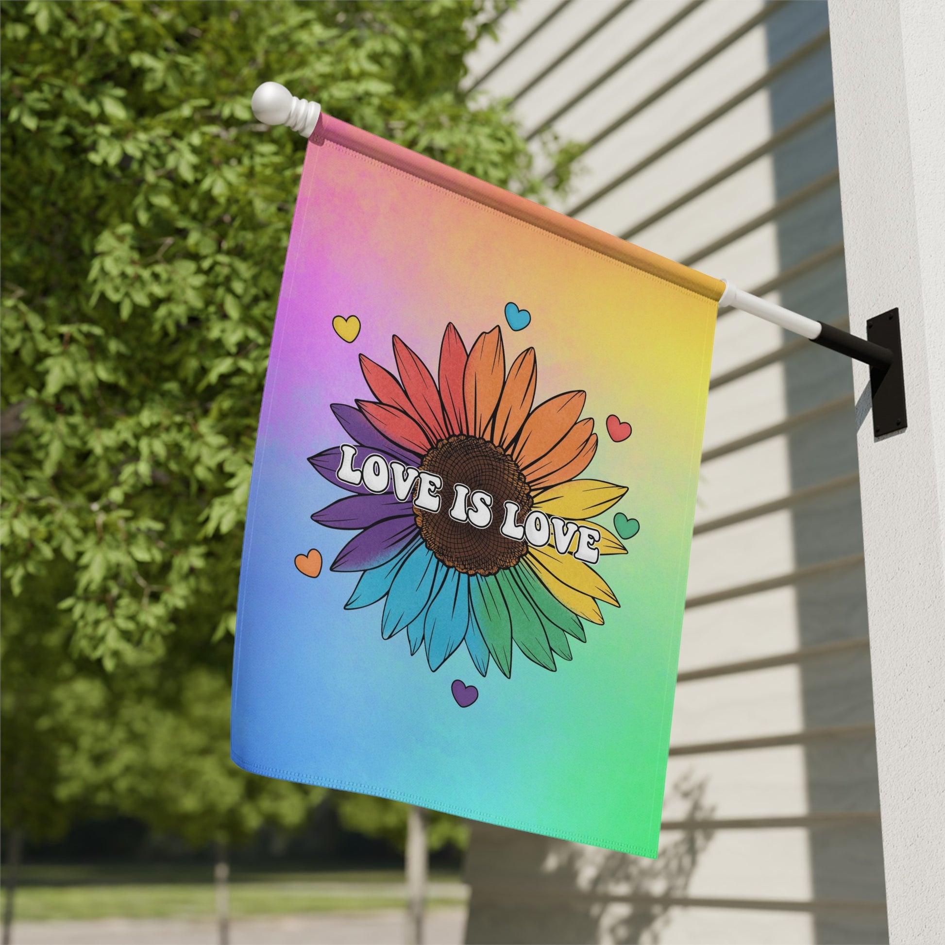 Sunflower with "Love is Love" text on a rainbow gradient flag.