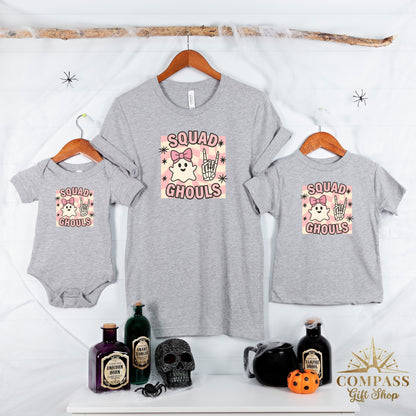 Grey t-shirts and onesie with "SQUAD GHOULS" graphic featuring ghosts and skeleton hands.