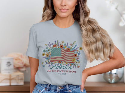 Light blue t-shirt with American flag and floral design, text "America 250 Years of Freedom 1776-2026".