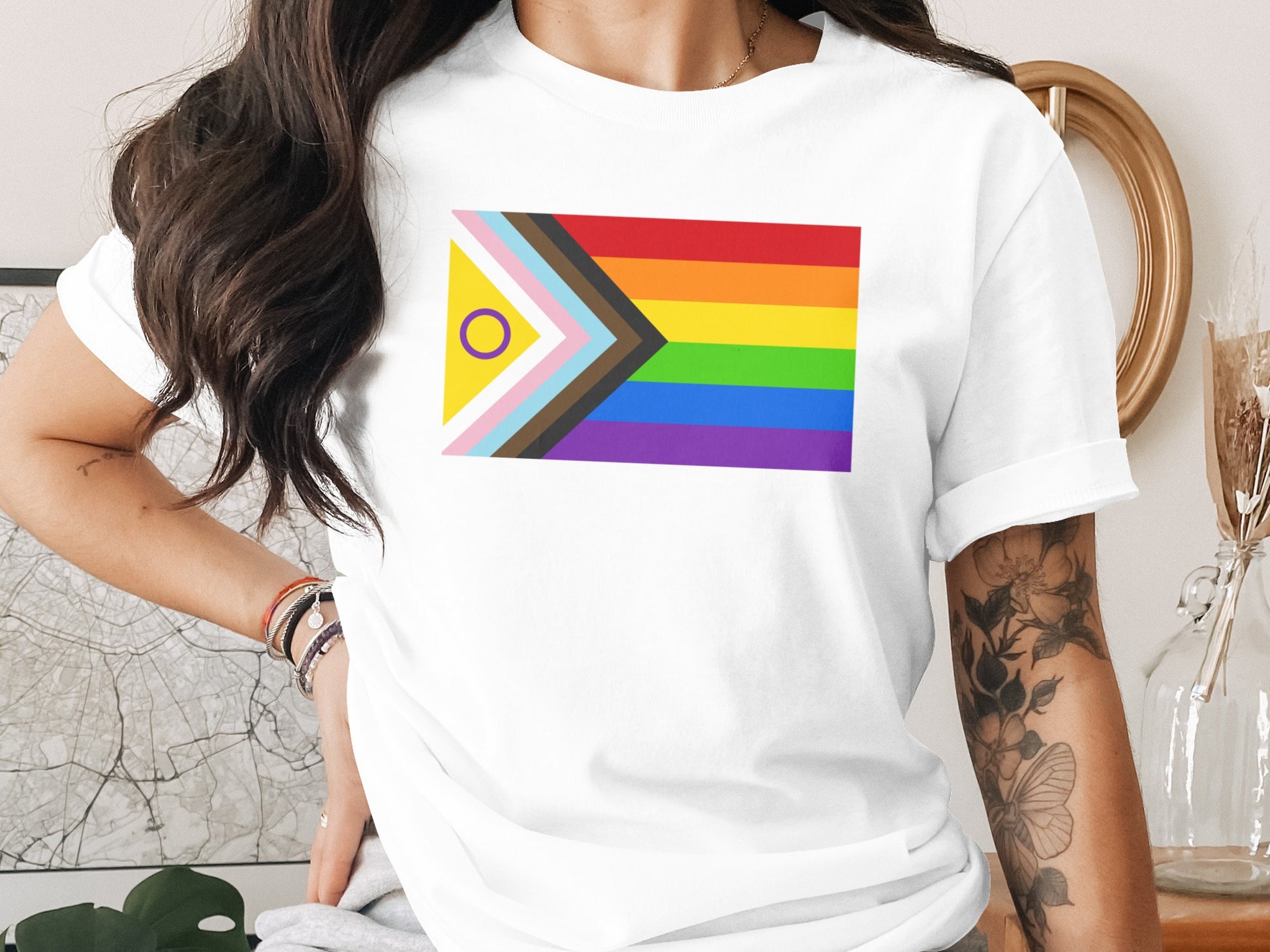 White t-shirt with inclusive pride flag design across chest.