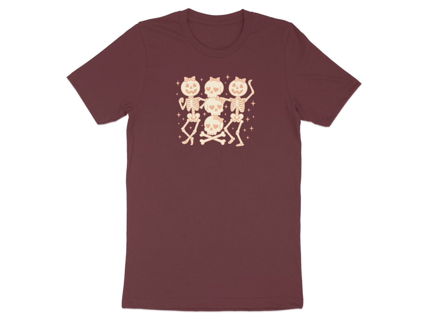 Three dancing skeletons with bow details and crossed bones on a maroon t-shirt.
