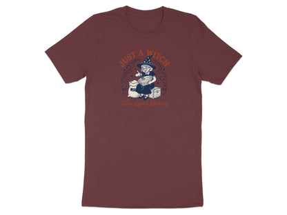T-shirt with graphic of a witch baking, text reads "Just A Witch Who Loves Baking".