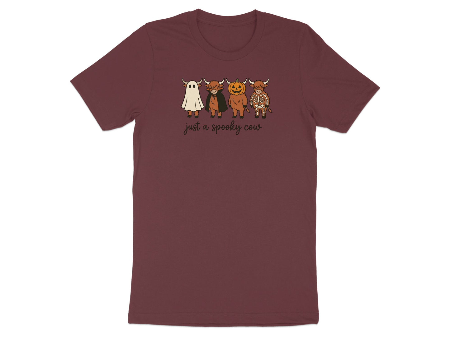 Maroon t-shirt with four cows dressed as a ghost, vampire, pumpkin, and skeleton.