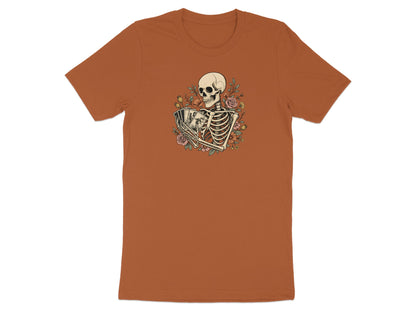 Skeleton holding playing cards surrounded by flowers on a copper t-shirt.