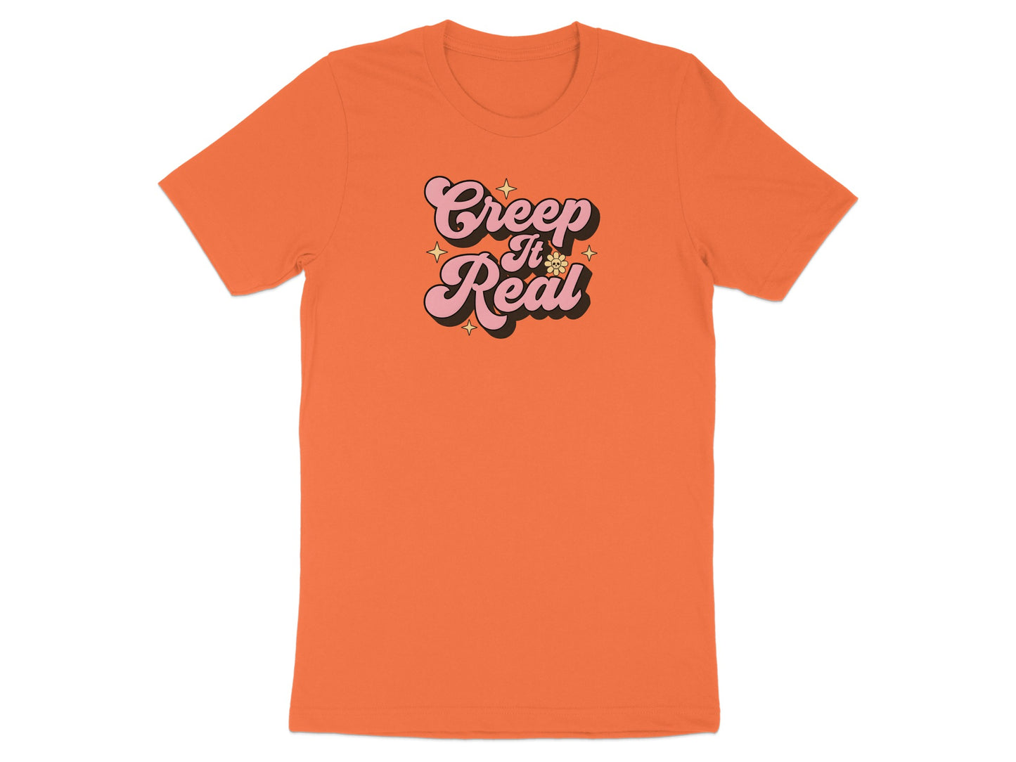 Orange t-shirt with "Creep It Real" text and small stars.