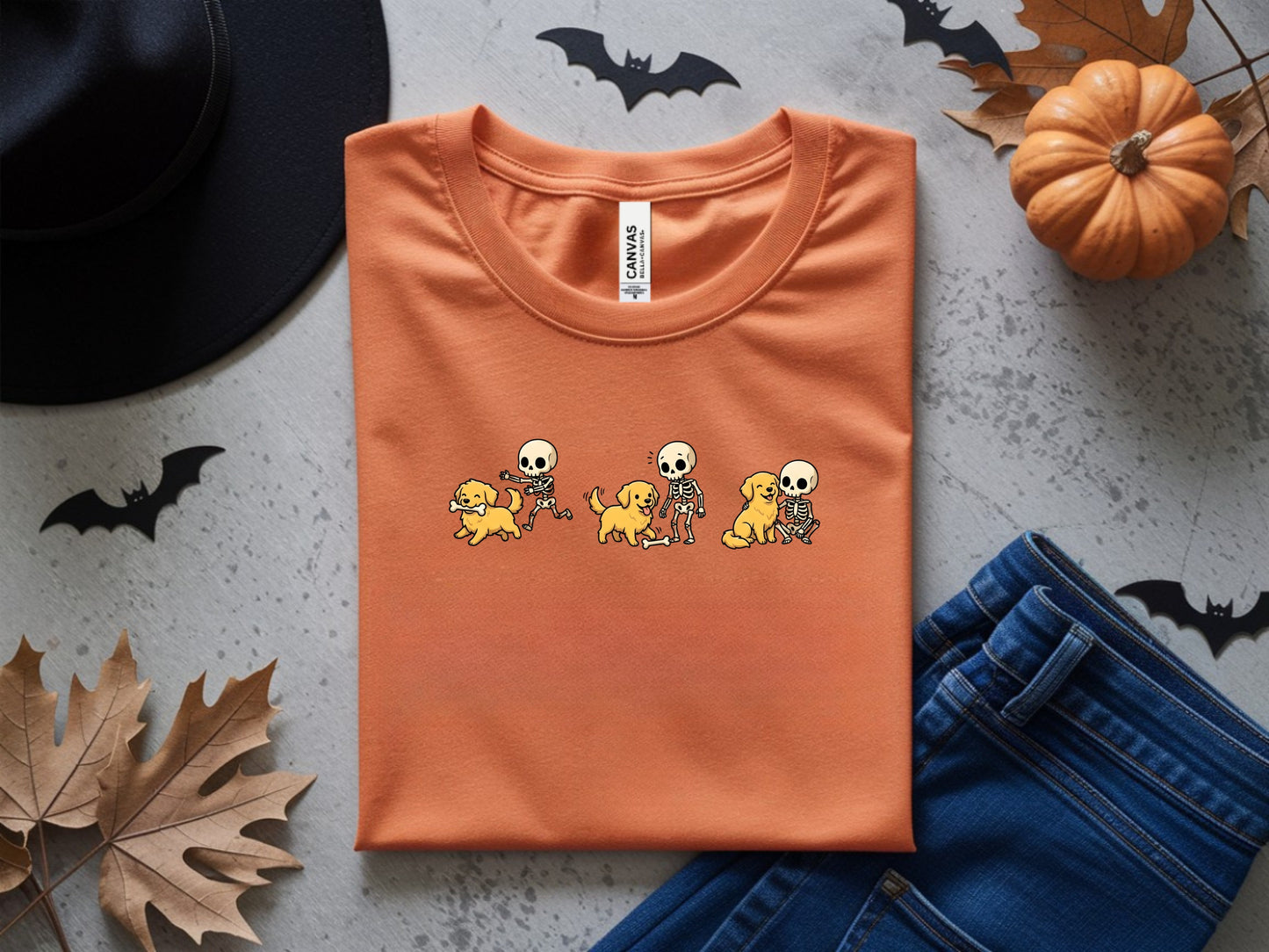 Orange t-shirt with a graphic of skeletons playing with golden retrievers.