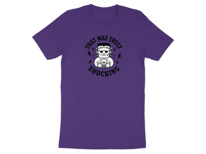 Purple t-shirt with Frankenstein's monster holding a lightbulb and text "That Was Truly Shocking".