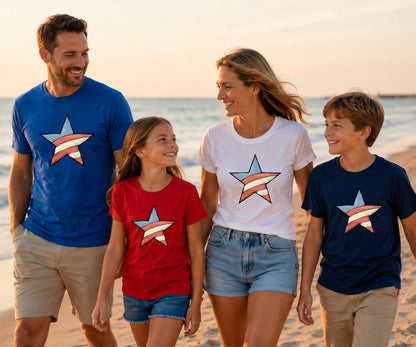 Family wearing patriotic star t-shirts on a beach at sunset.