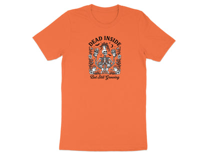 Orange t-shirt with skeleton holding plants and text "DEAD INSIDE But Still Growing".