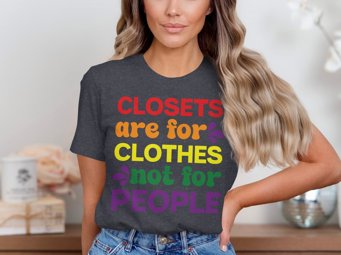 Dark grey t-shirt with "Closets are for clothes not for people" text in rainbow colors.