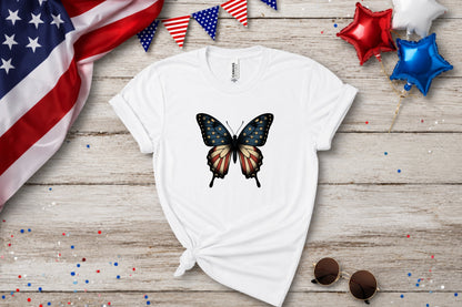 White t-shirt with distressed American flag butterfly graphic, patriotic bunting and balloons.