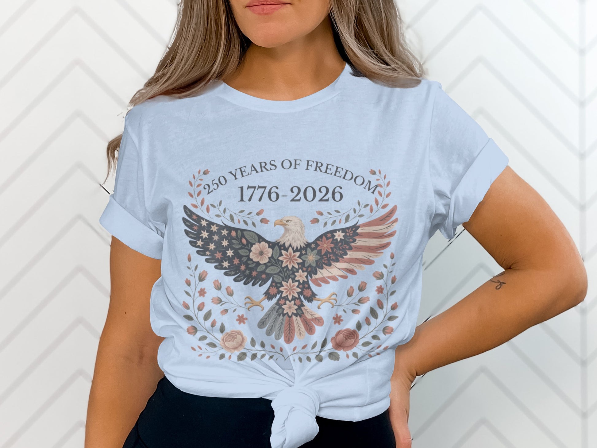 Eagle with American flag wings and floral wreath, "250 Years of Freedom 1776-2026".