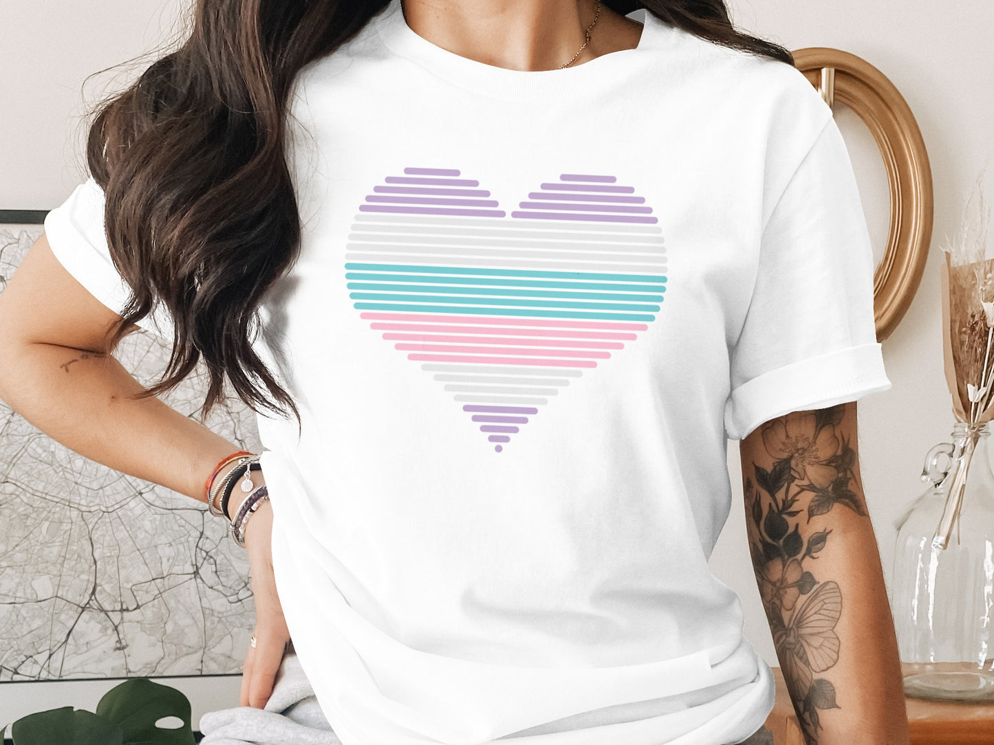 White t-shirt with a pastel striped heart graphic.
