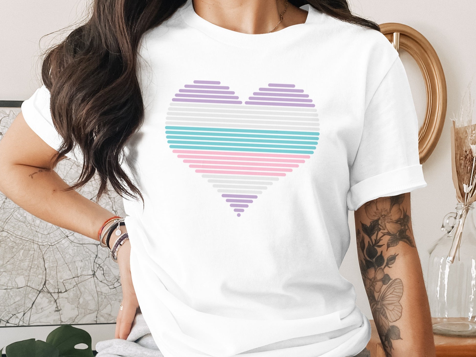 White t-shirt with a pastel striped heart graphic.
