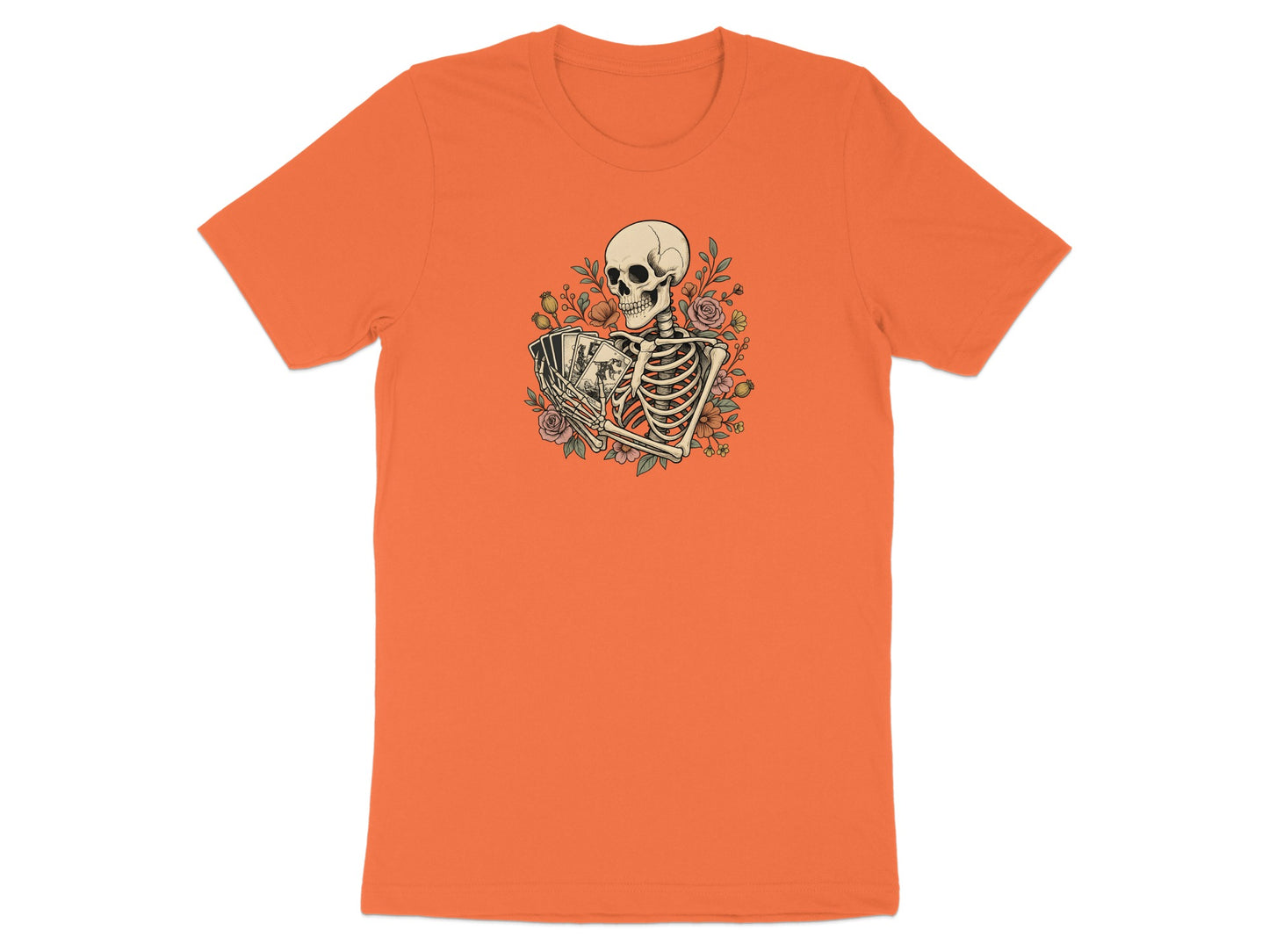 Skeleton holding playing cards surrounded by flowers on an orange t-shirt.