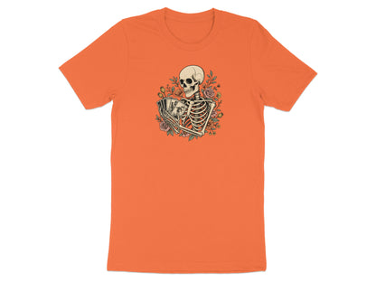 Skeleton holding playing cards surrounded by flowers on an orange t-shirt.