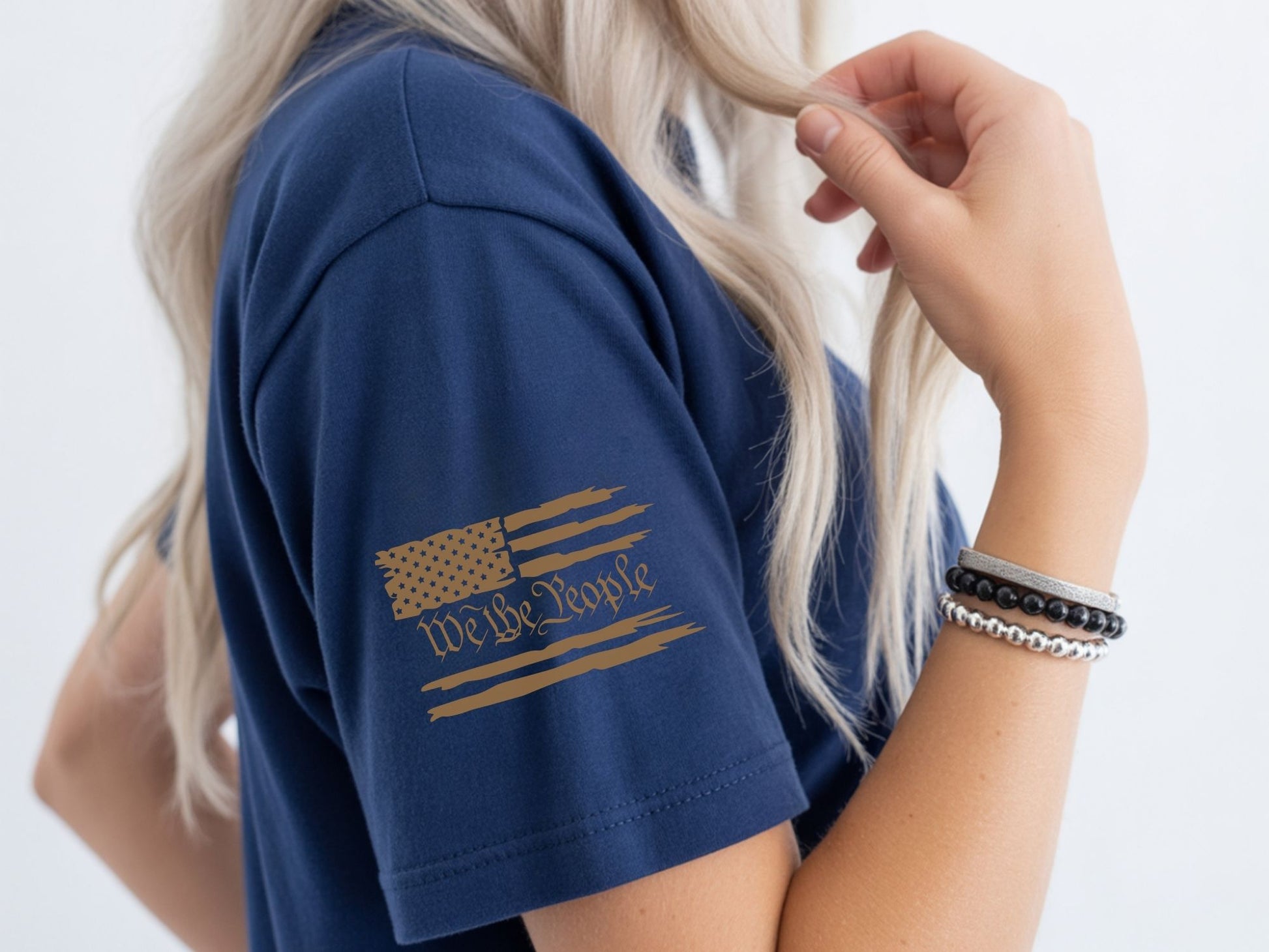Navy t-shirt with distressed American flag and "We The People" text on sleeve.