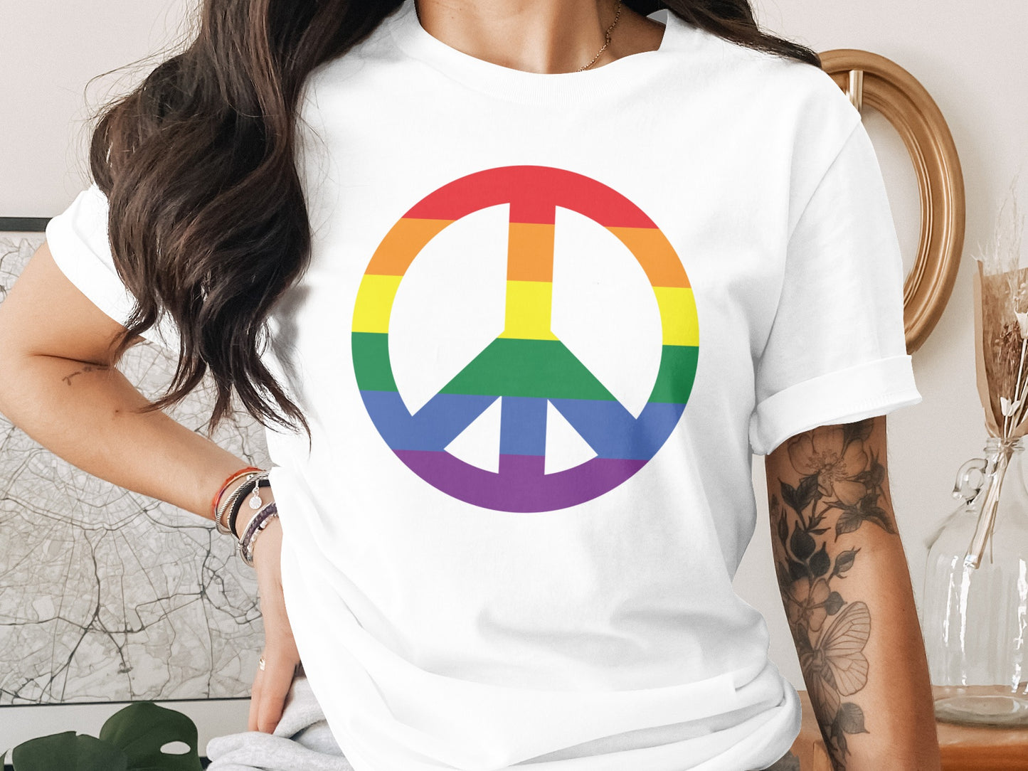 White t-shirt with a rainbow peace sign graphic.