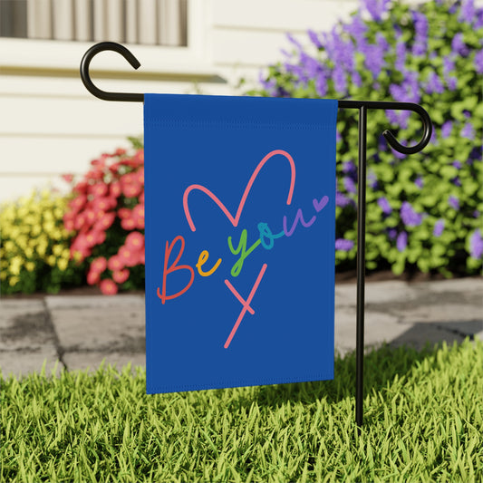 Blue garden flag with "Be Your X" in rainbow colors and a heart.