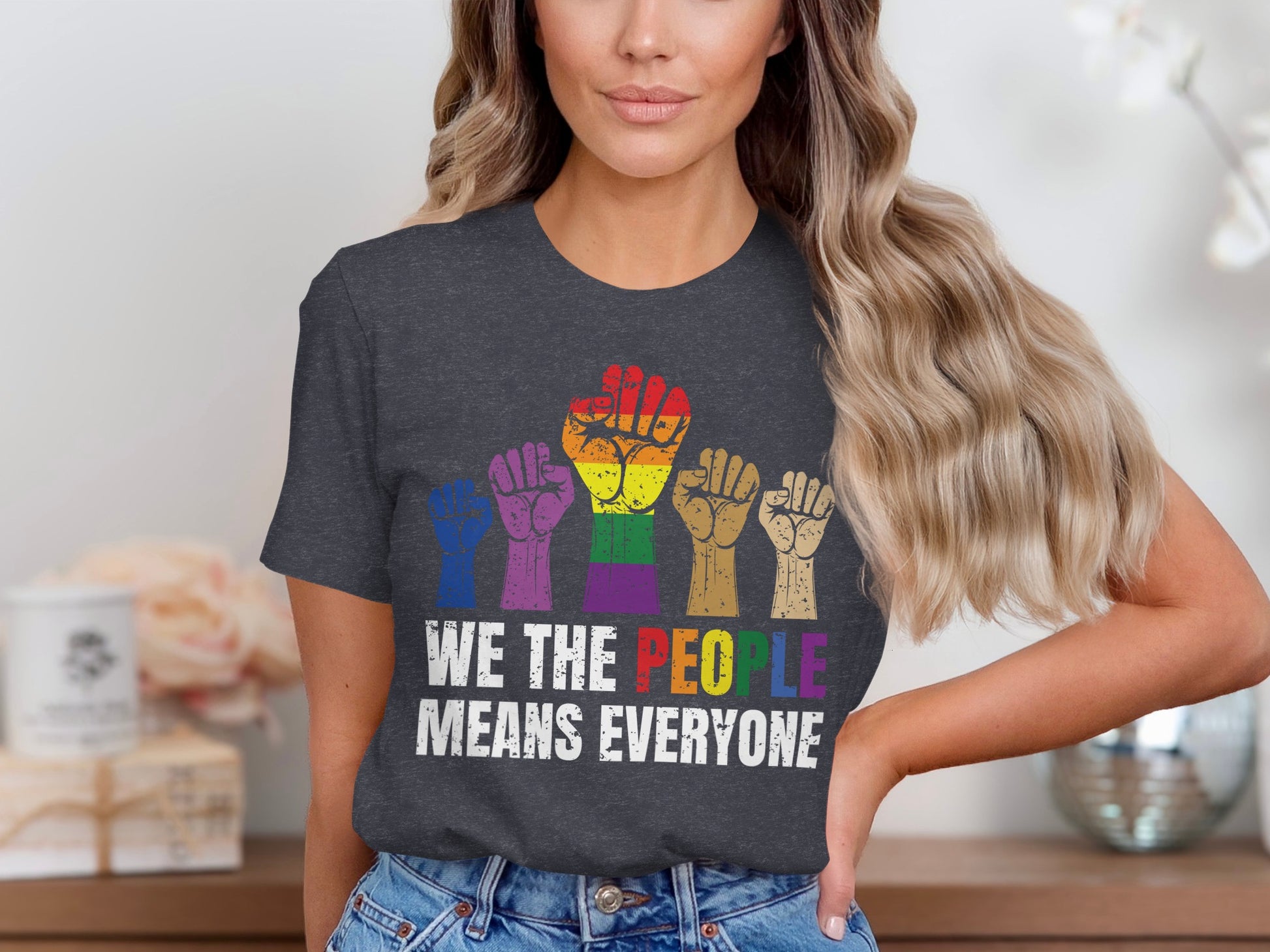T-shirt with "WE THE PEOPLE MEANS EVERYONE" and rainbow fists.
