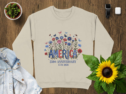 Cream sweatshirt with "AMERICA 250TH ANNIVERSARY 1776-2026" text and floral design.
