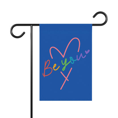 Garden flag with "Be your" and a heart in rainbow colors.