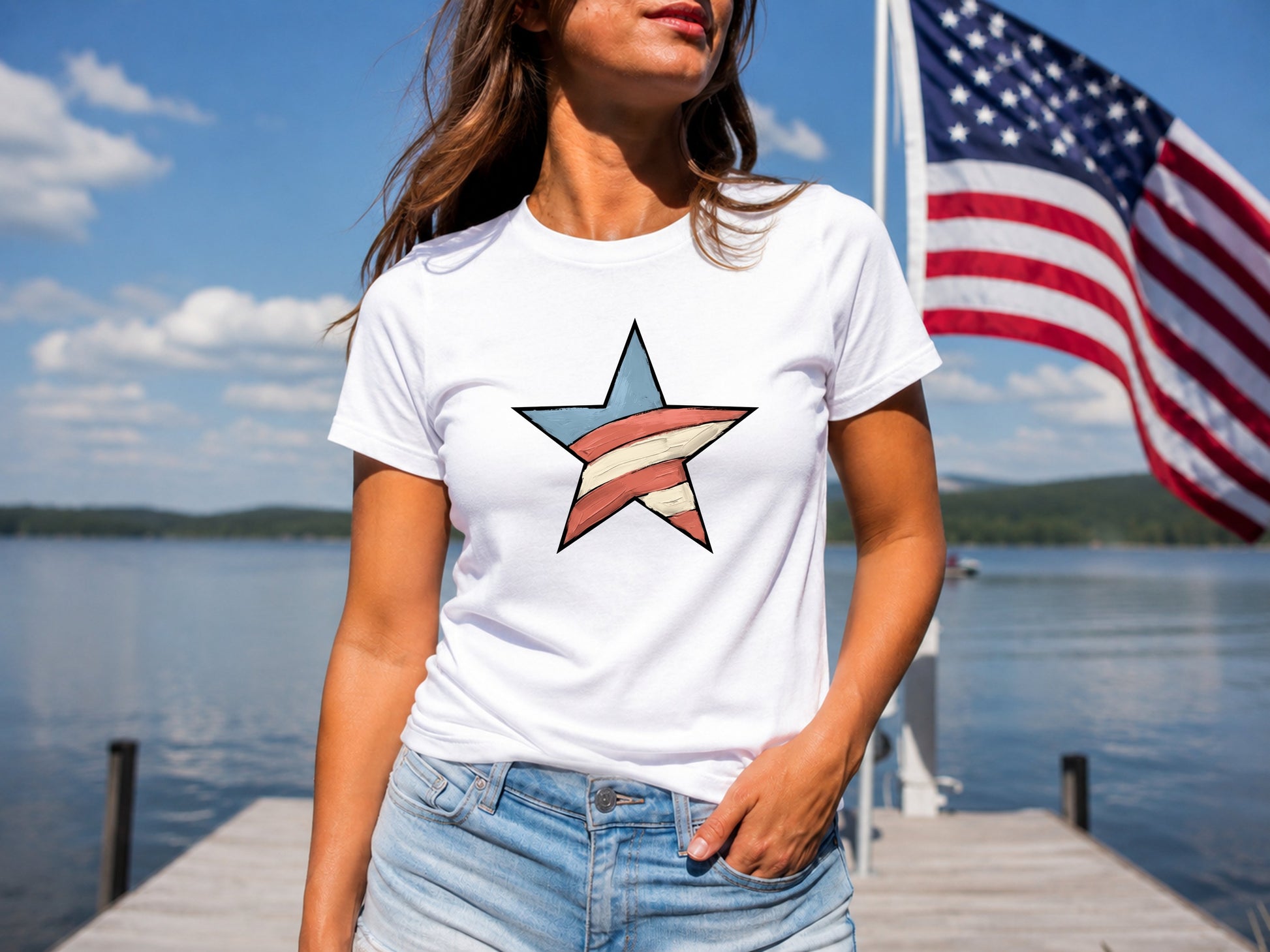 Woman in white t-shirt with red, white, and blue star on a dock with American flag.