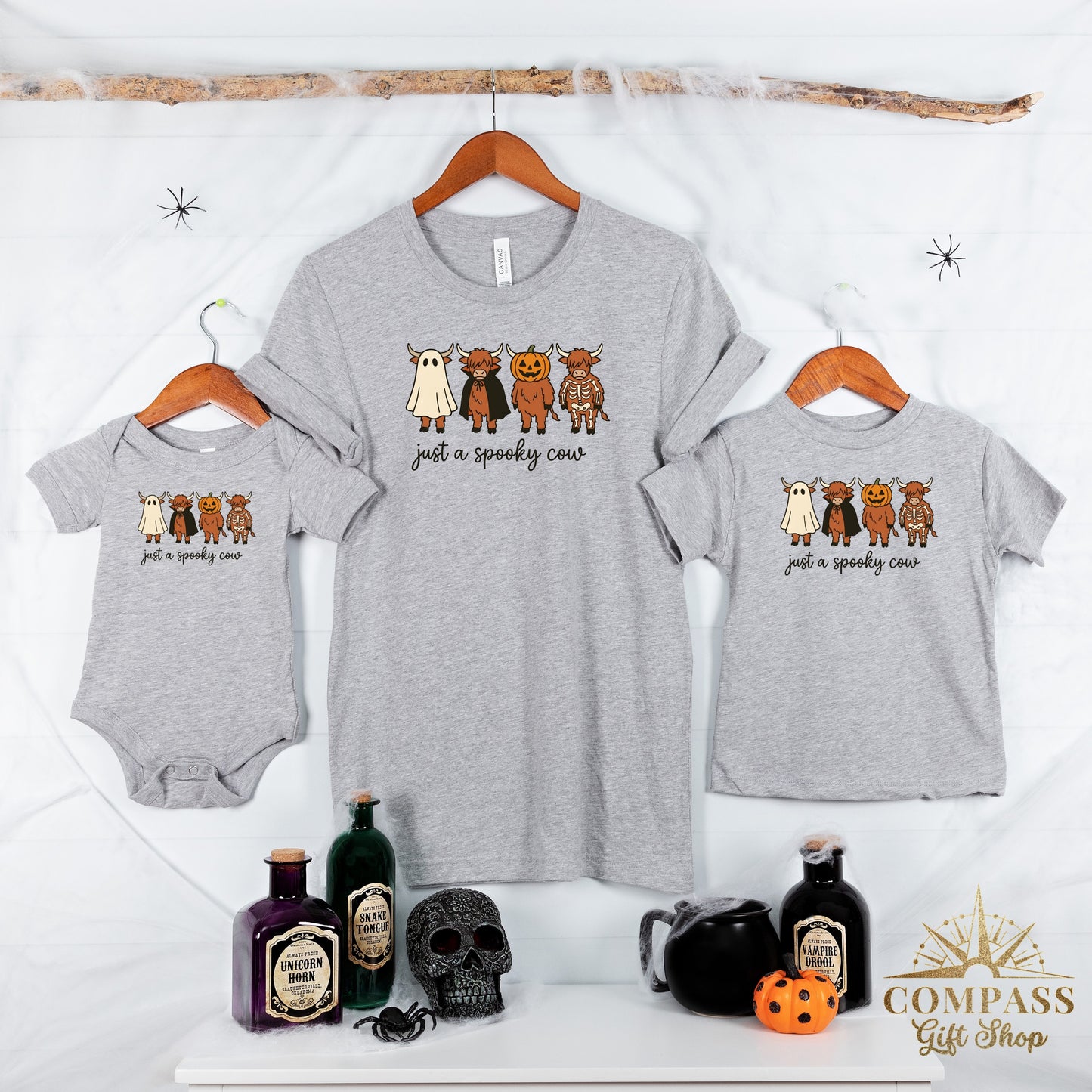 Grey shirts and a onesie with cartoon cows dressed as ghosts, vampires, pumpkins, and skeletons.