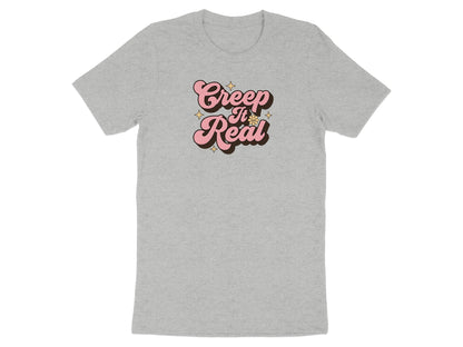 Grey t-shirt with pink "Creep It Real" text and yellow stars.