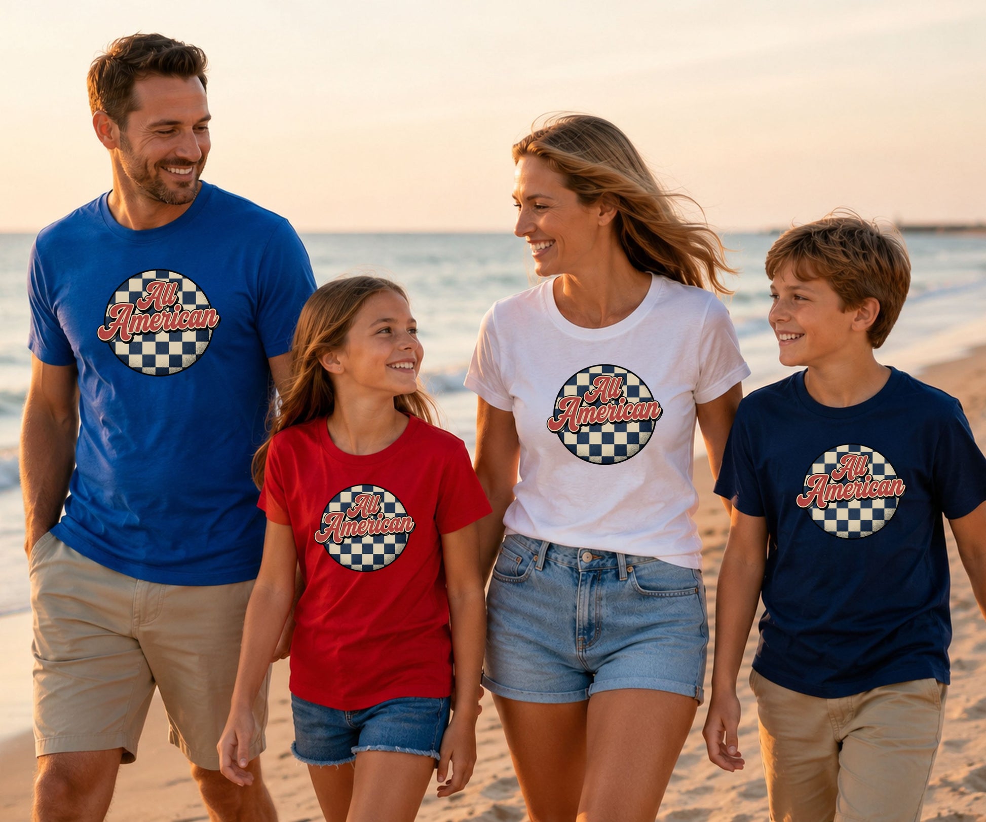 Family wearing matching checkered flag "All American" t-shirts on the beach.