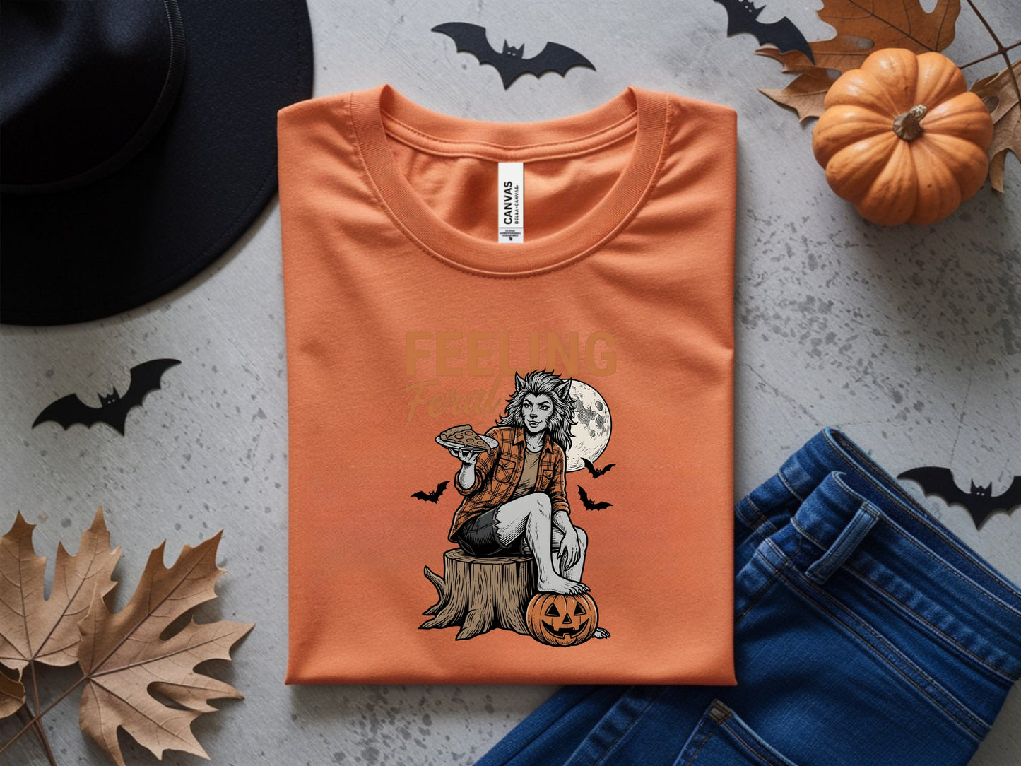 Orange t-shirt with werewolf holding pie, saying "Feeling Feral" in the moonlight.