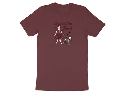 Maroon t-shirt with "A Girl's Best Fiend" text and illustration of woman with skeleton dog.