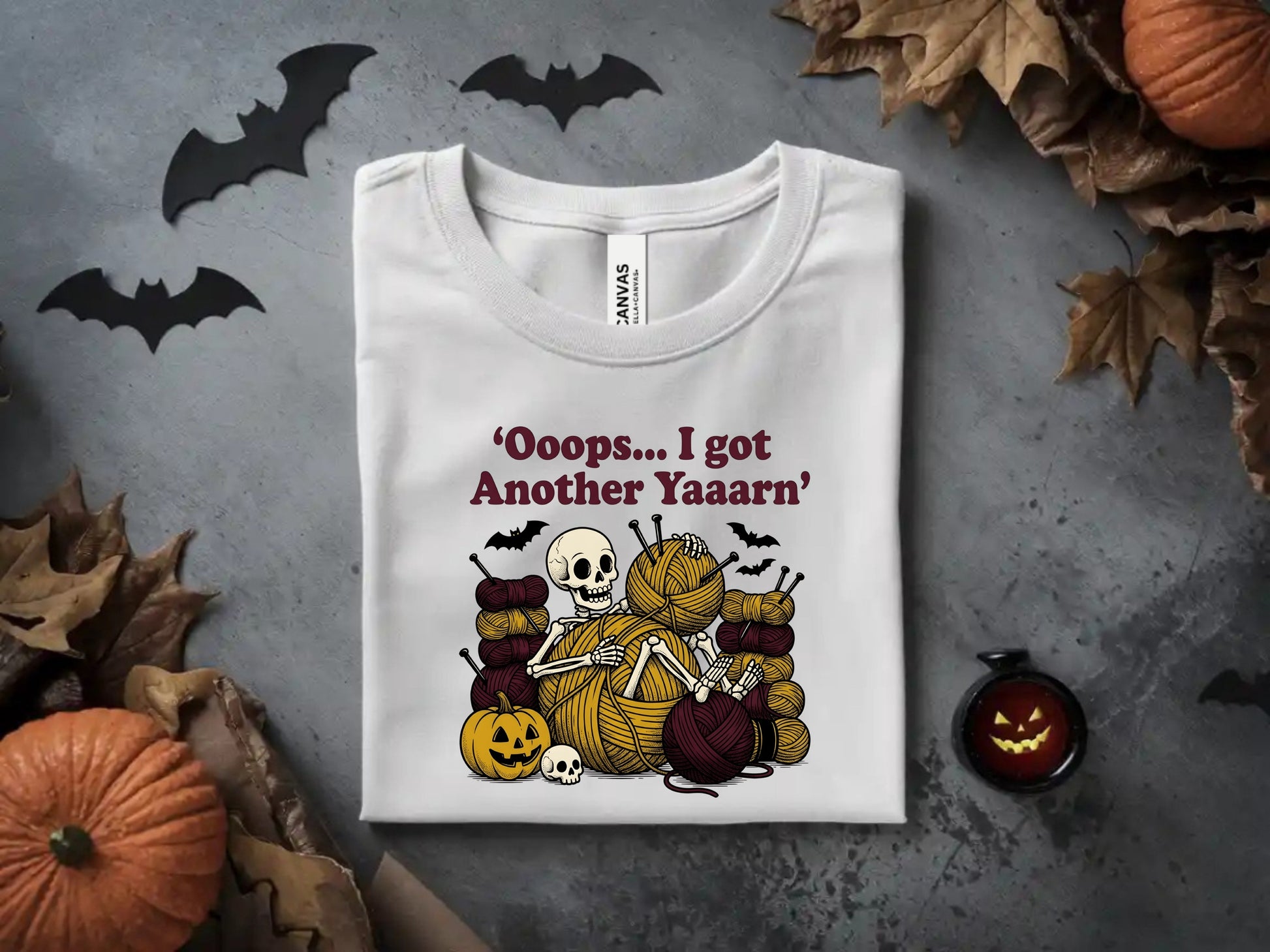 White t-shirt with skeleton and yarn graphic, "Ooops... I got Another Yaaarn" text.