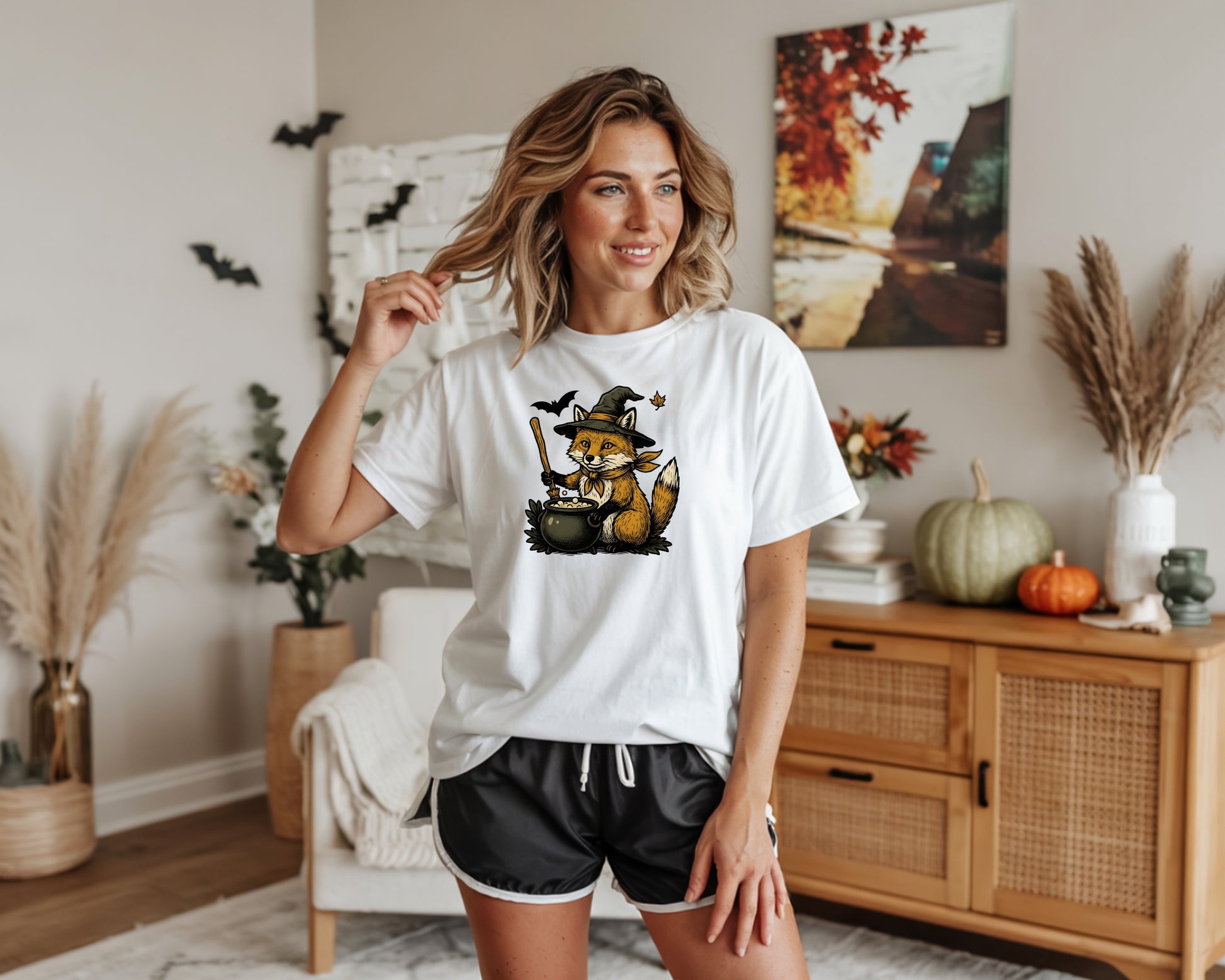 White t-shirt with a fox in a witch hat brewing in a cauldron graphic.