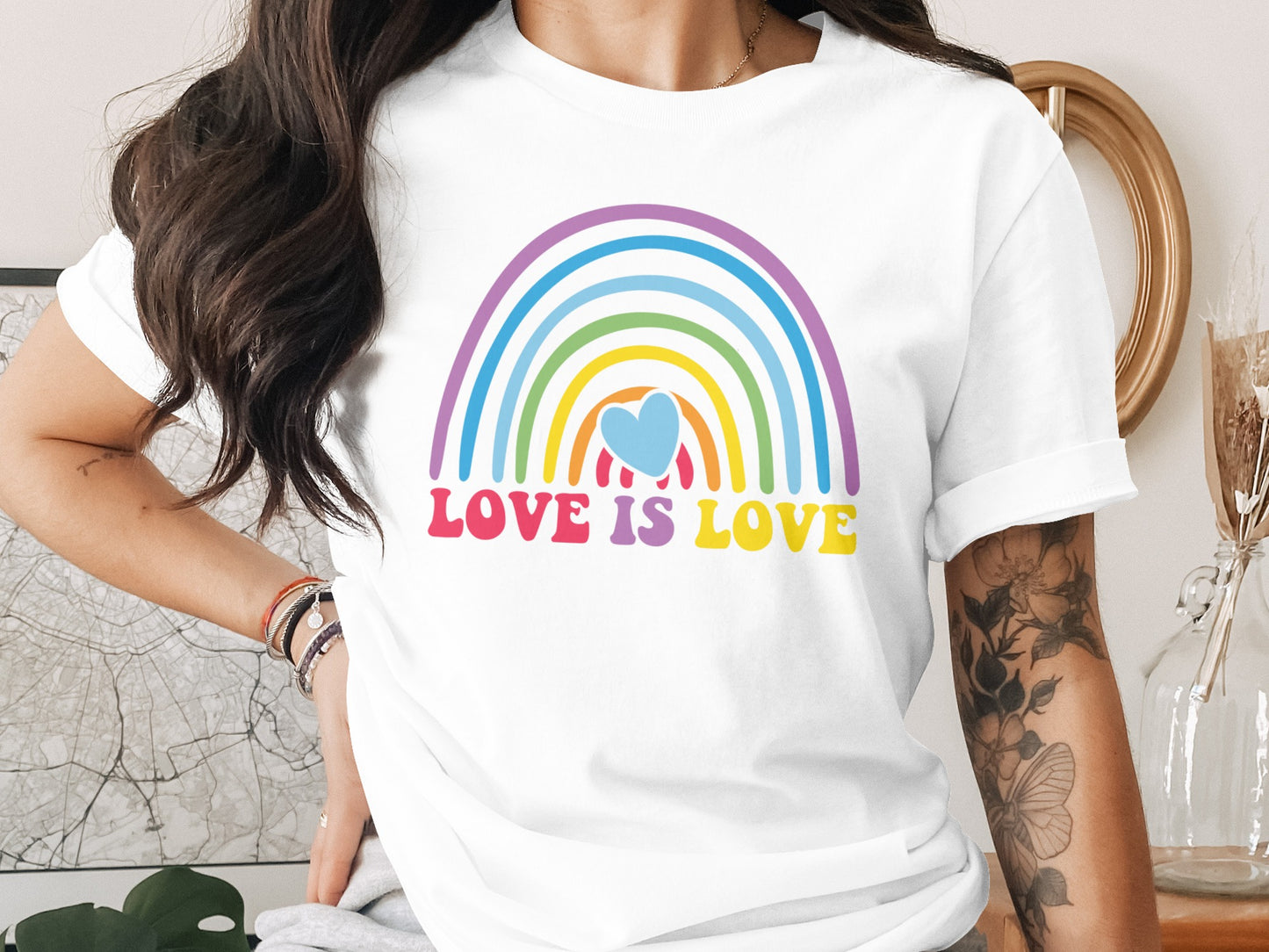 White t-shirt with rainbow and "LOVE IS LOVE" text.