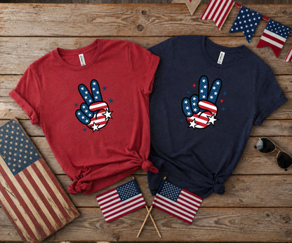 Two t-shirts with patriotic peace signs, USA flags and sunglasses.