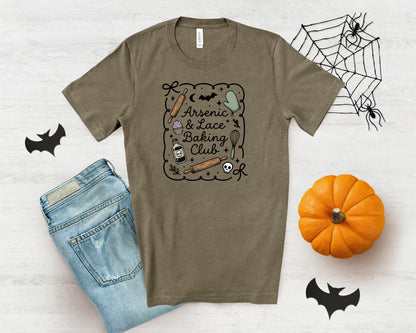 Brown t-shirt with "Arsenic & Lace Baking Club" text and Halloween-themed graphics.