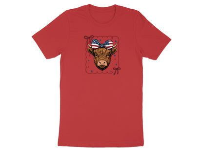Highland cow wearing a patriotic bow on a red t-shirt.