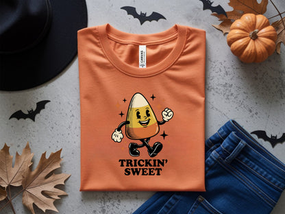 Orange t-shirt with a cartoon candy corn character and "Trickin' Sweet" text.