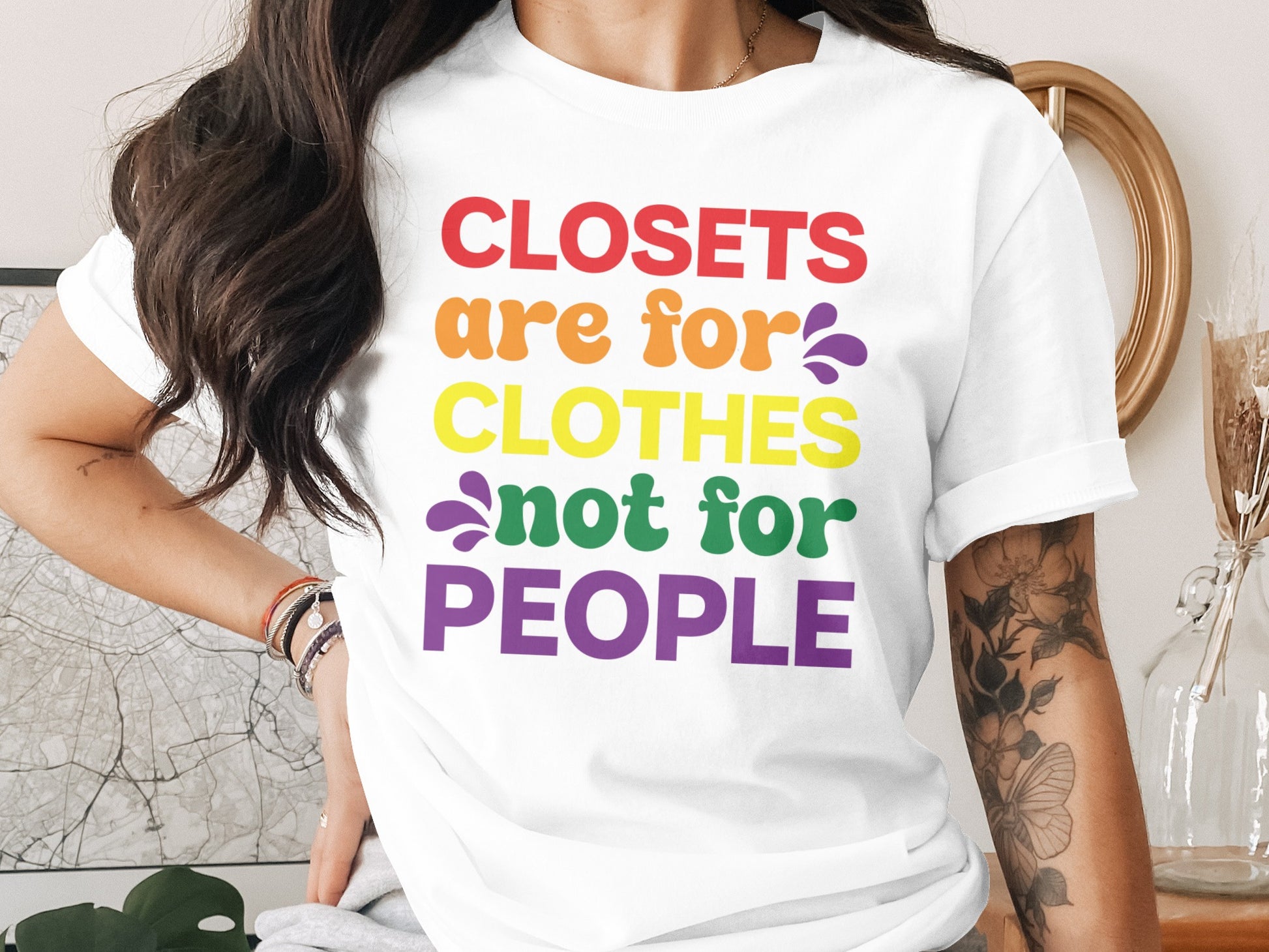 White t-shirt with rainbow text: Closets are for clothes, not for people.