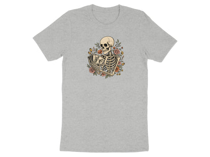 Skeleton holding playing cards surrounded by flowers on a grey t-shirt.
