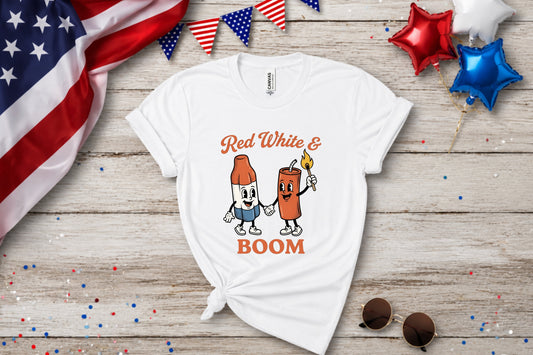 White t-shirt with cartoon firecracker and bottle with "Red White & Boom".