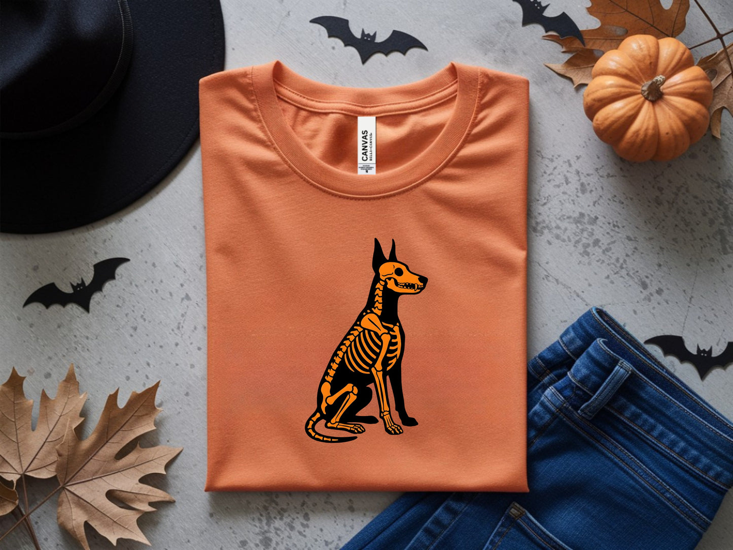 Orange t-shirt with a black and orange dog skeleton graphic.