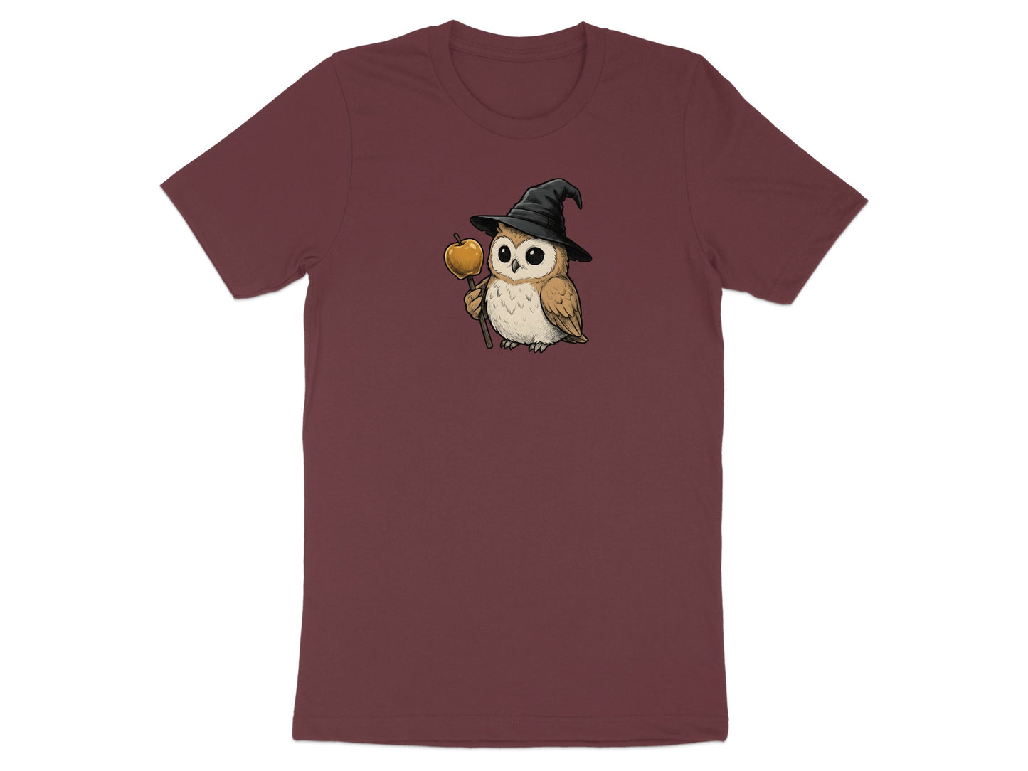 T-shirt with illustration of a cute owl wearing a witch hat and holding an apple on a stick.