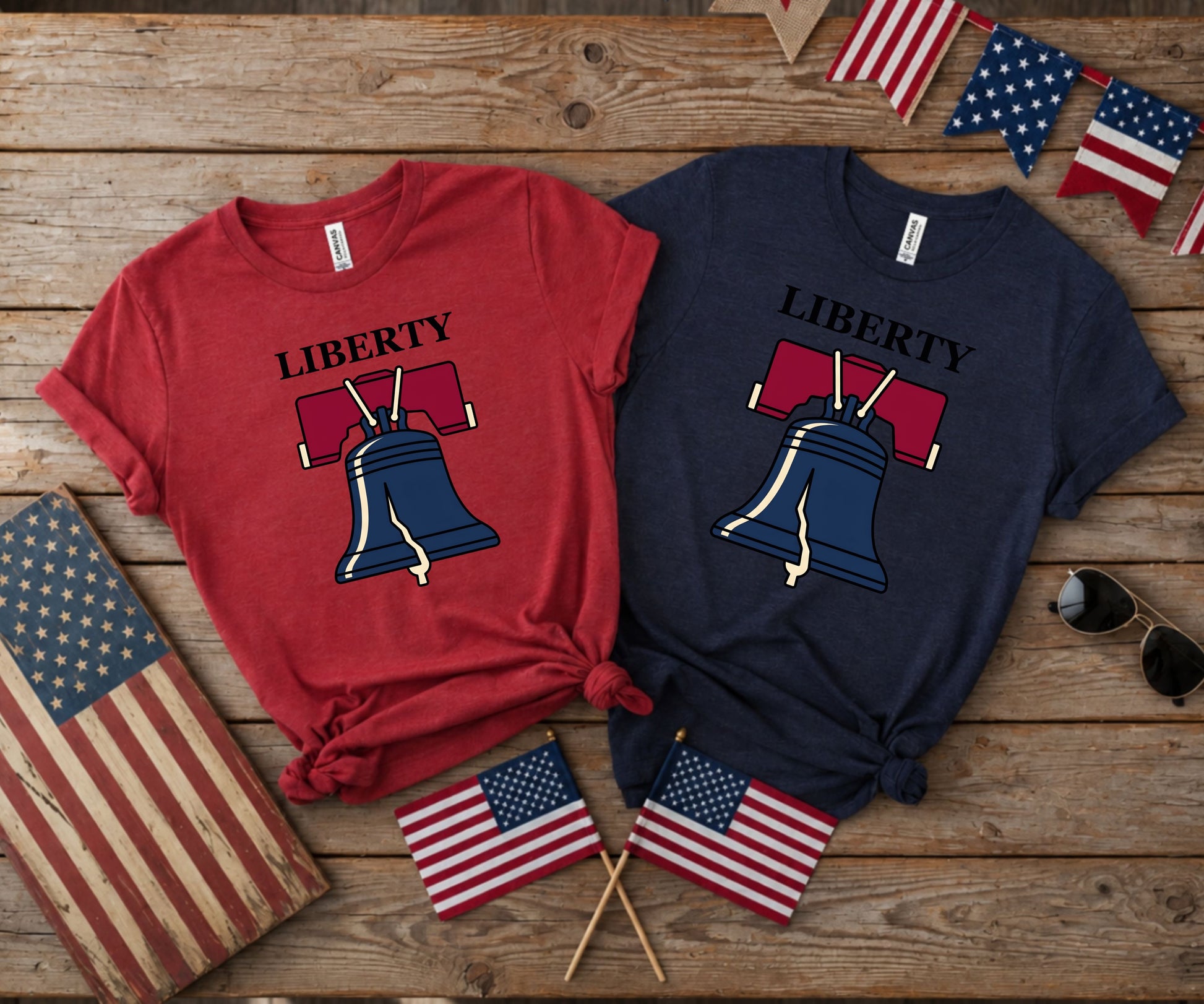 Two t-shirts, one red, one navy, with Liberty Bell graphic.