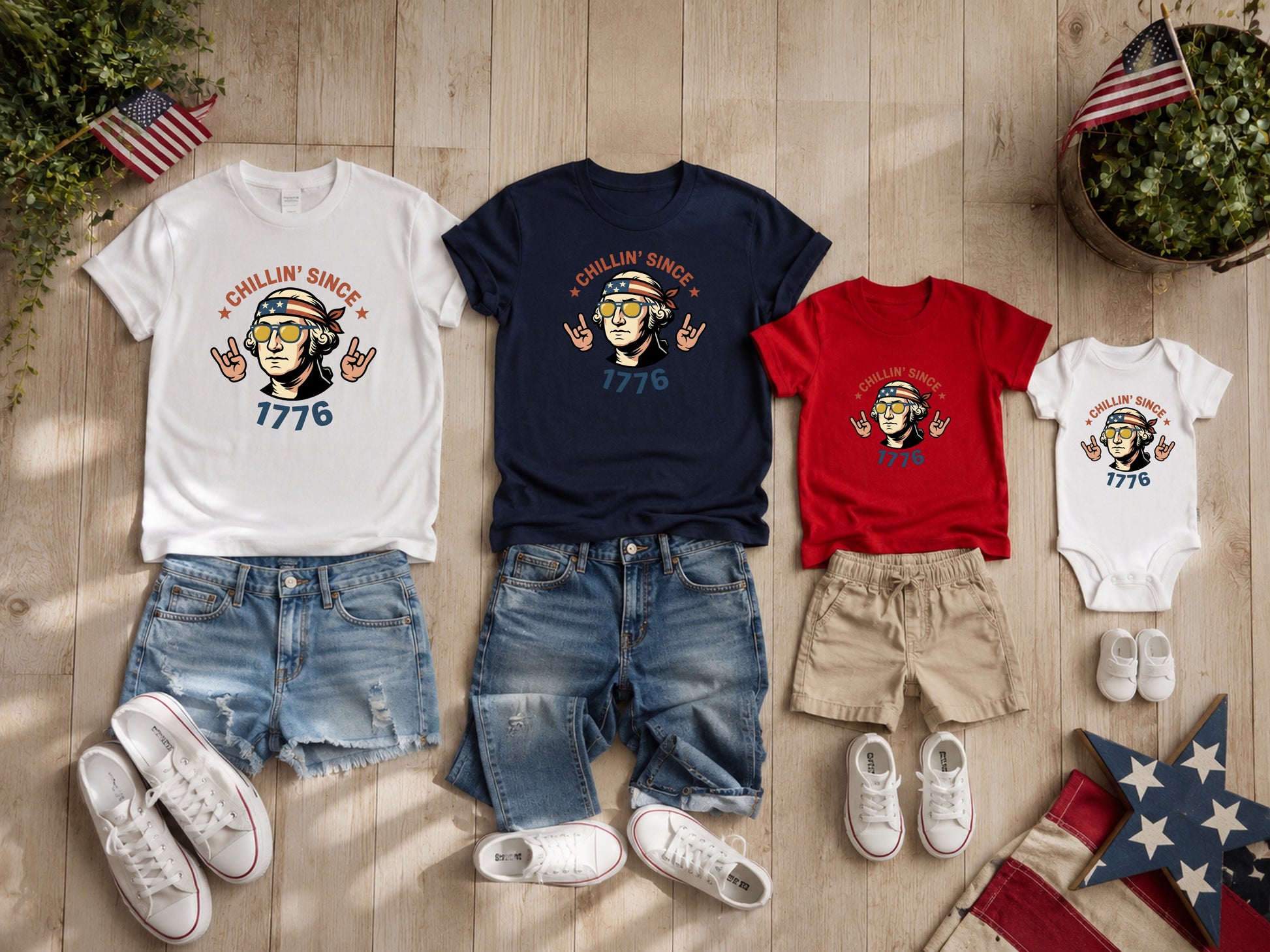 Four "Chillin' Since 1776" graphic tees and matching shorts displayed with patriotic decor.
